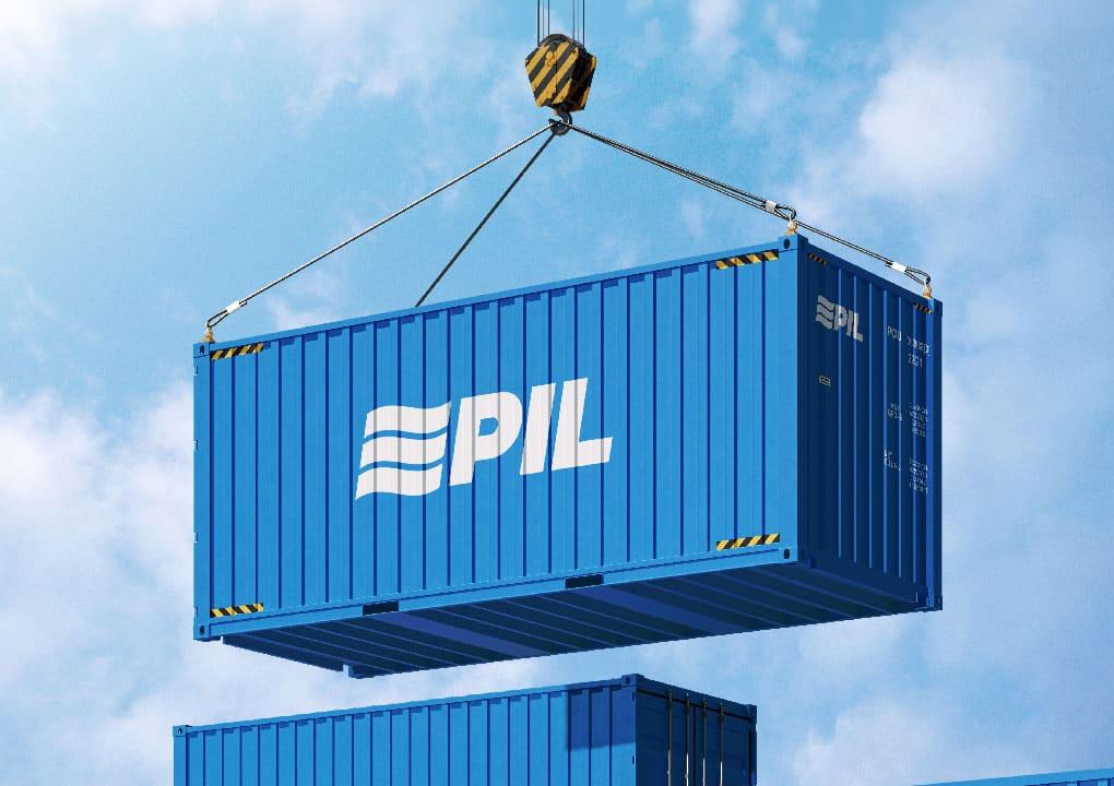 Blue PIL shipping container lifted by a crane against the sky