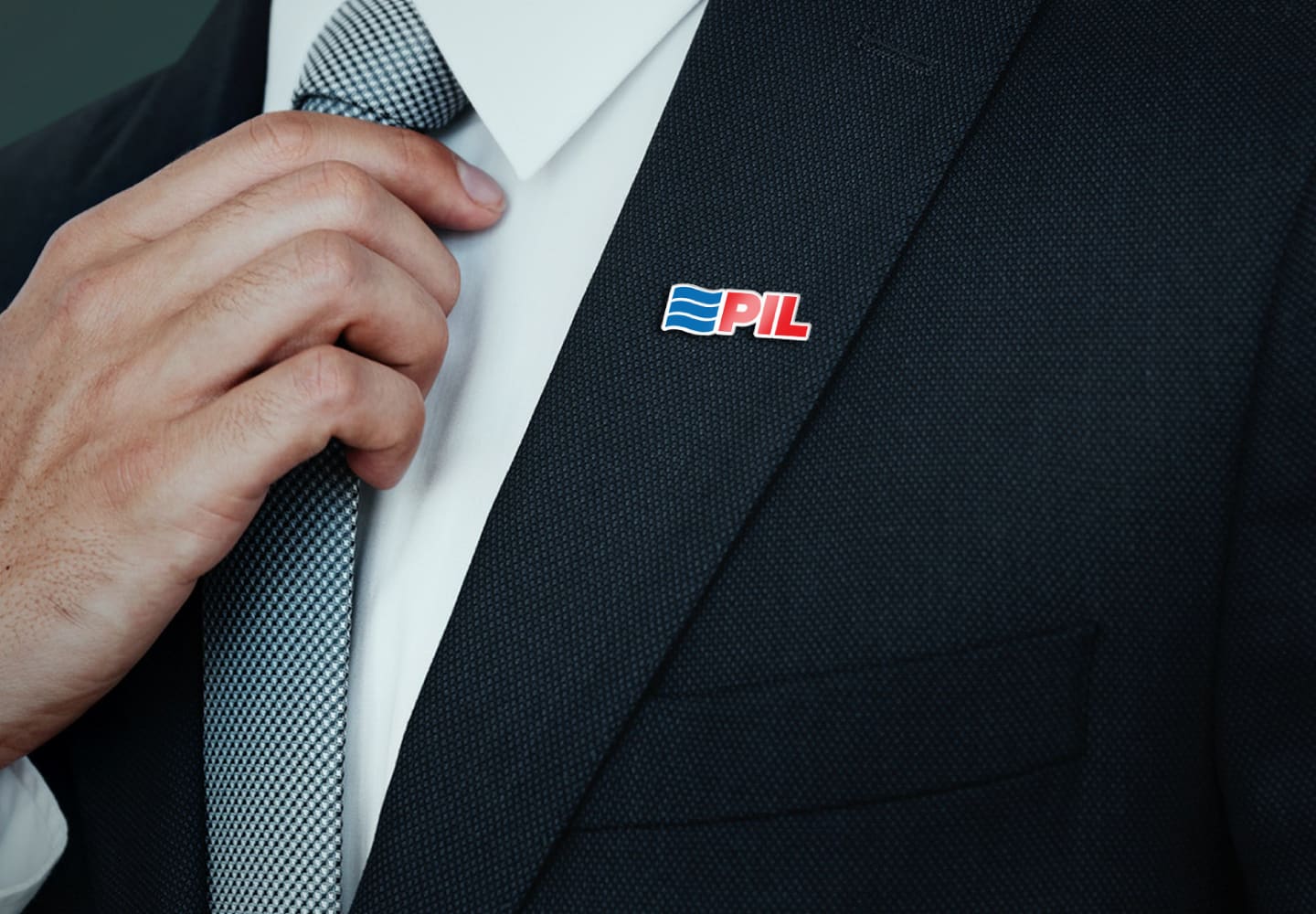 PIL lapel pin on a dark suit